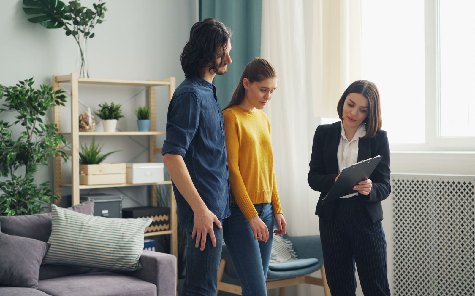 A couple viewing a home with a real estate professional