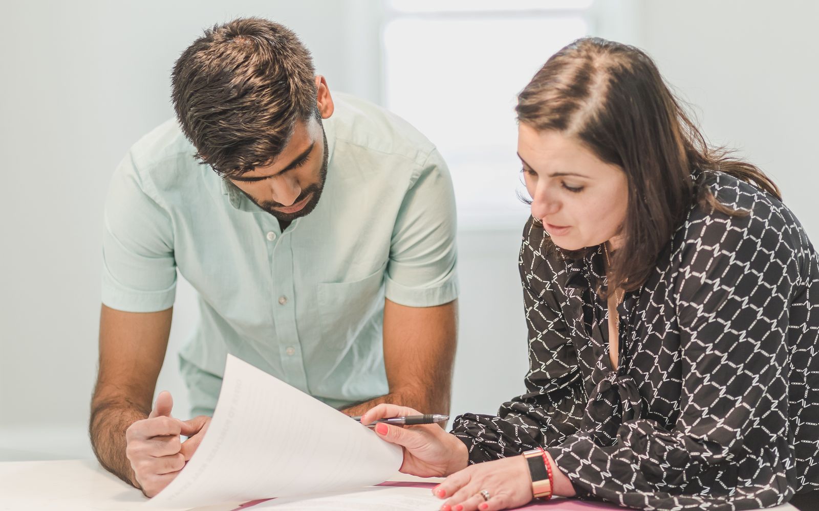 A couple reviewing paperwork together at home