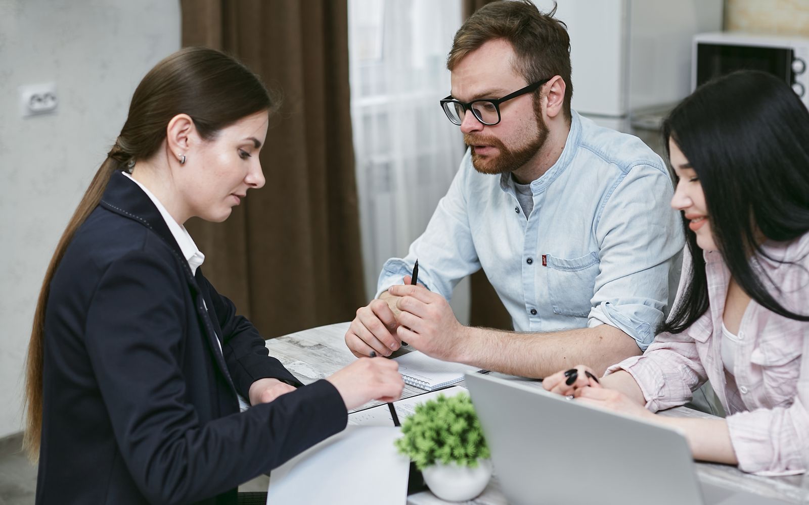 A couple reviewing mortgage documents with an advisor
