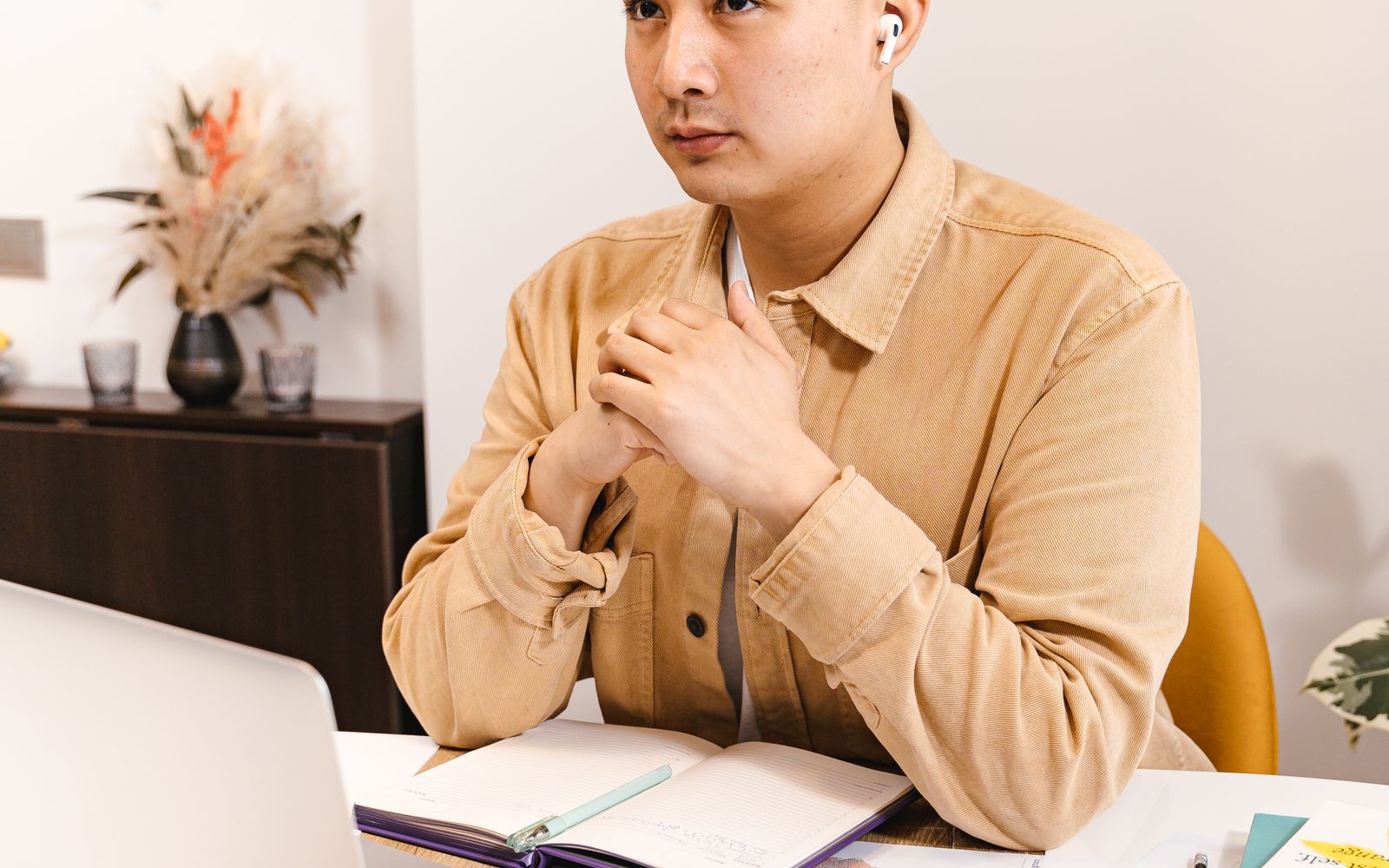 A self-employed professional working on documents at a desk